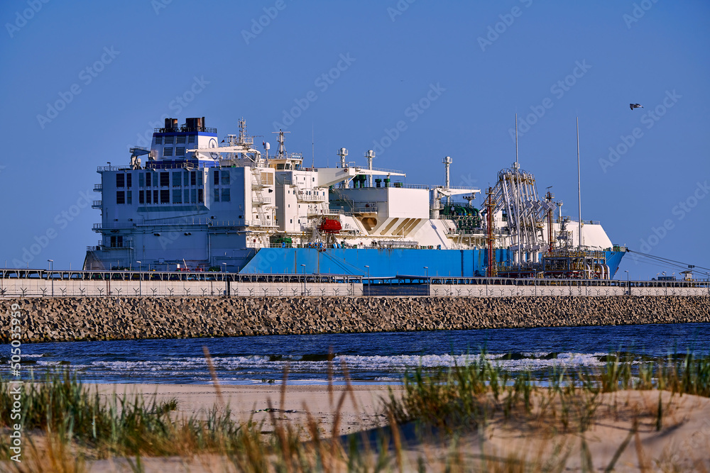 Świnoujście, Poland - May-15-2022: LNG transportation vessel Maran Gas Appolonia while discharging at terminal for liquified gas, connections, equipment and pressure reducers at baltic sea. Świnoujście, Poland - May-15-2022: LNG transportation vessel Maran Gas Appolonia while discharging at terminal for liquified gas, connections, equipment and pressure reducers at baltic sea.