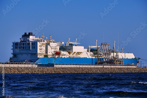 Świnoujście, Poland - May-15-2022: LNG transportation vessel Maran Gas Appolonia while discharging at terminal for liquified gas, connections, equipment and pressure reducers at baltic sea.  photo