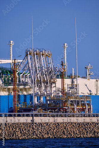 Świnoujście, Poland - May-15-2022: LNG transportation vessel Maran Gas Appolonia while discharging at terminal for liquified gas, connections, equipment and pressure reducers at baltic sea.  photo