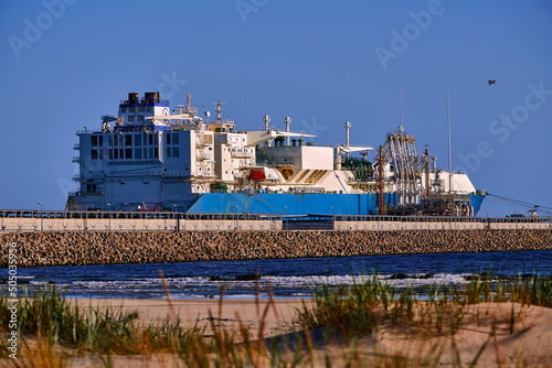 Świnoujście, Poland - May-15-2022: LNG transportation vessel Maran Gas Appolonia while discharging at terminal for liquified gas, connections, equipment and pressure reducers at baltic sea.  photo