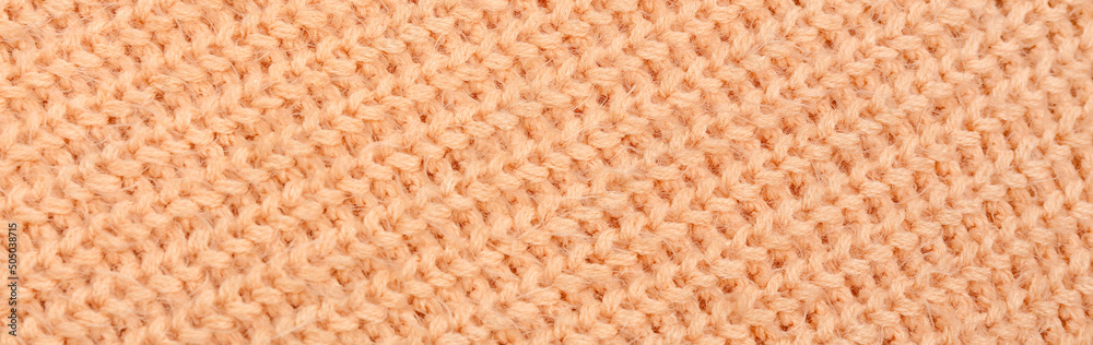 Texture of beige knitted fabric as background. Banner for design Texture of beige knitted fabric as background. Banner for design