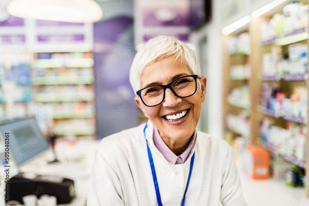 Portrait of a smiling mature healthcare worker in modern pharmacy.