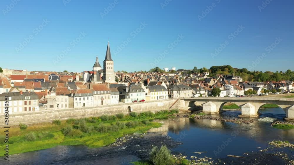The medieval town center of Charite sur Loire in front of its Loire bridge in Europe, France, Burgundy, Nievre, in summer, on a sunny day. The medieval town center of Charite sur Loire in front of its Loire bridge in Europe, France, Burgundy, Nievre, in summer, on a sunny day.
