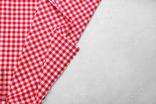 Red checkered tablecloth for picnic on light background