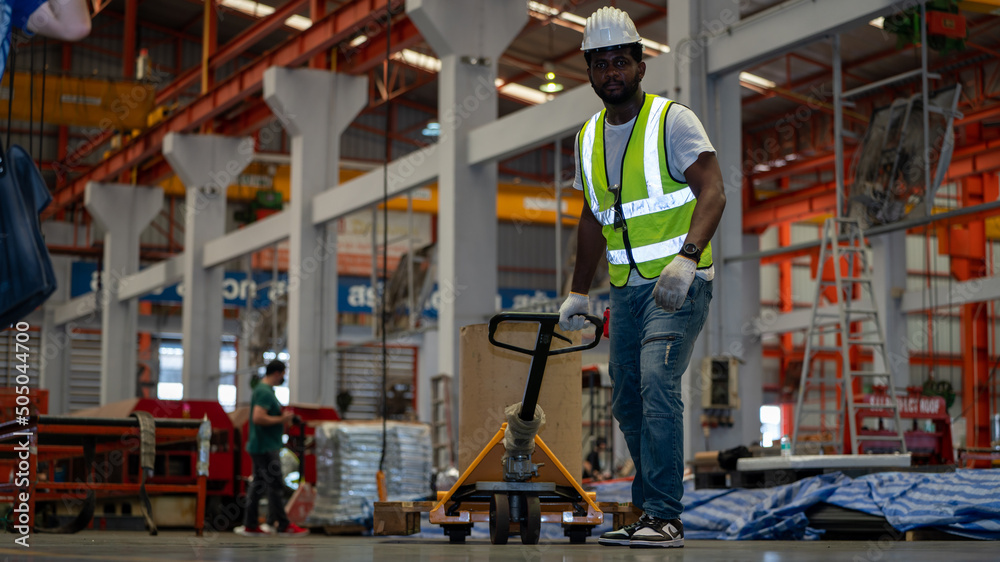 Fototapeta premium Diverse Team of Workers use Hand Pallet Truck Start Loading in Manufacturing Factory industry concept