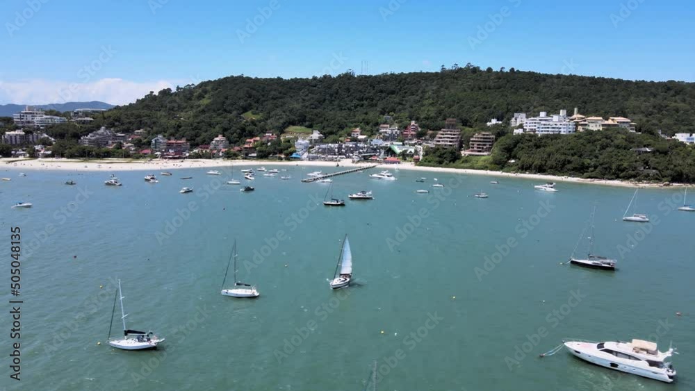 Aerial drone image of tropical beach with many people on the sand with boats and yachts sailing in the sea people enjoying the beach with sails near the shore trapuche pier of boats on the beach Aerial drone image of tropical beach with many people on the sand with boats and yachts sailing in the sea people enjoying the beach with sails near the shore trapuche pier of boats on the beach