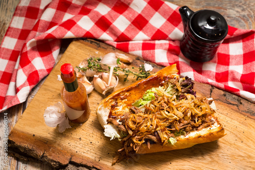 New Orleans Roast Beef Debris Po Boy sandwich. Slow Cooked Roast Beef stew filling, fried onion chips and a hot sauce.