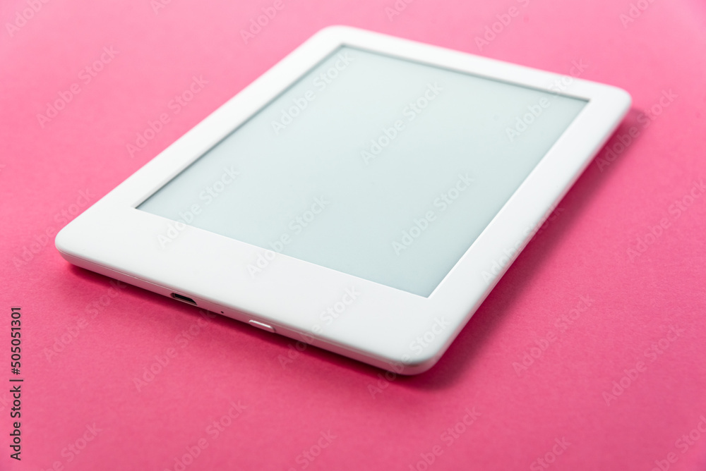 Ebook reader over pink background Ebook reader over pink background