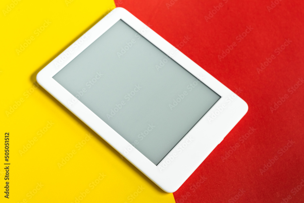 Ebook reader over yellow and red background Ebook reader over yellow and red background