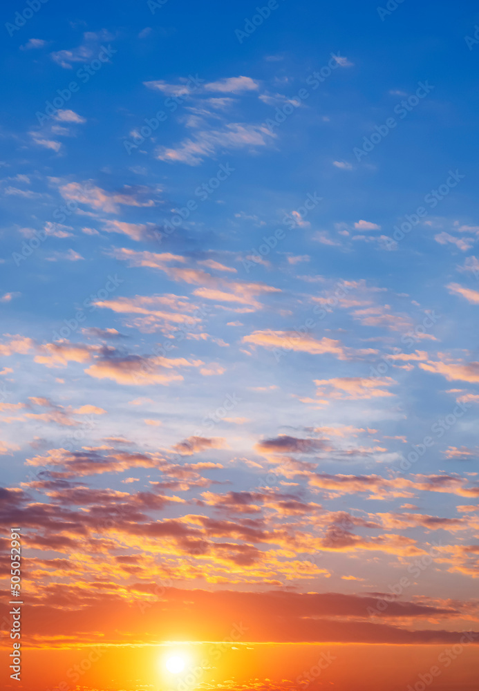 Colorful orange and blue sunset sky background at morning time in vertical frame