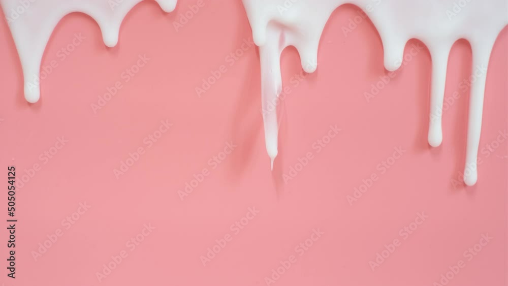 liquid moisturizing shampoo dripping down on pink background close-up