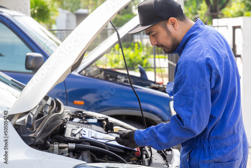 maintenance car using screwdriver. mechanic man hands holding tools fixing repair car engine.