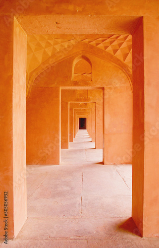 Orange corridor central view of consecutive doors