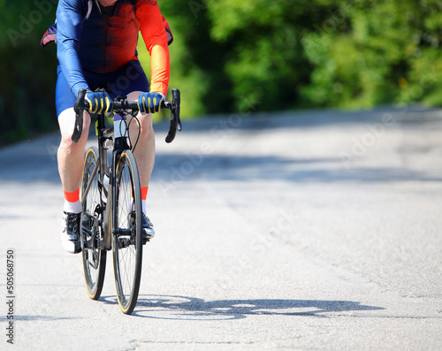 Fototapeta Naklejka Na Ścianę i Meble -  cyclist with sportswear while training pedaling on an asphalt road