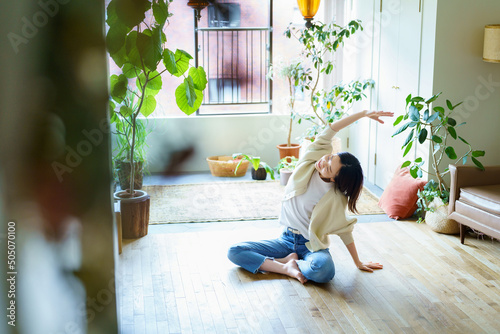 部屋でストレッチする女性 photo