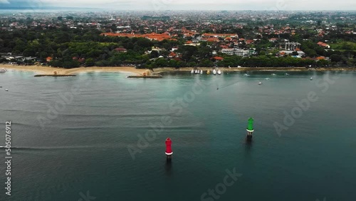 Beautiful cinematic Sanur beach, Bali drone footage with interesting landscape, fishing boats, hotel, resorts and calm weather. This footage was shot during Sunrise time in 1080p. photo