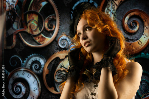 Portrait of a beautiful girl with red hair in a steampunk suit 