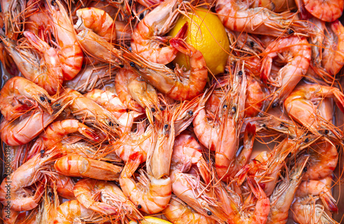 Lots of boiled sea shrimps with lemon.