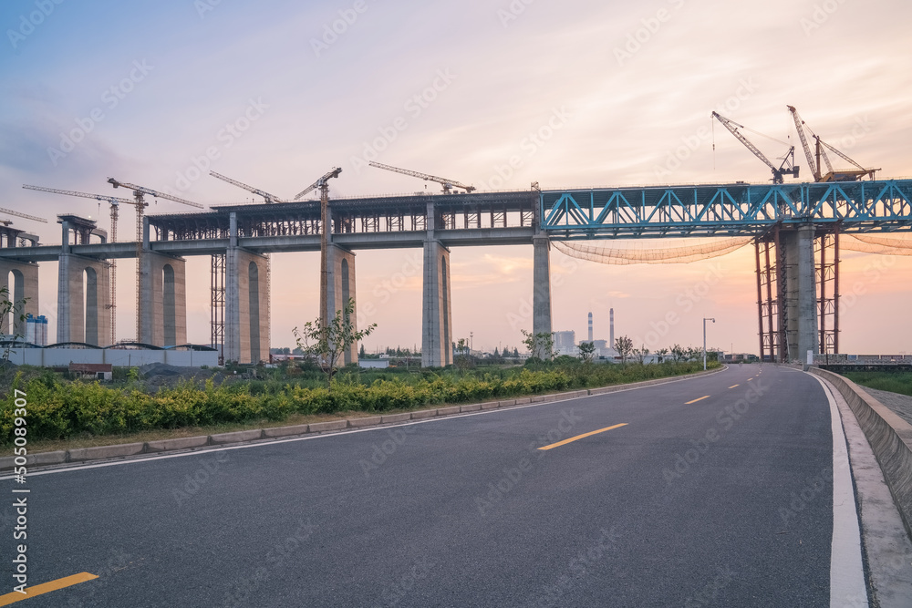 Yangtze River Bridge and asphalt road under construction in Suzhou, China