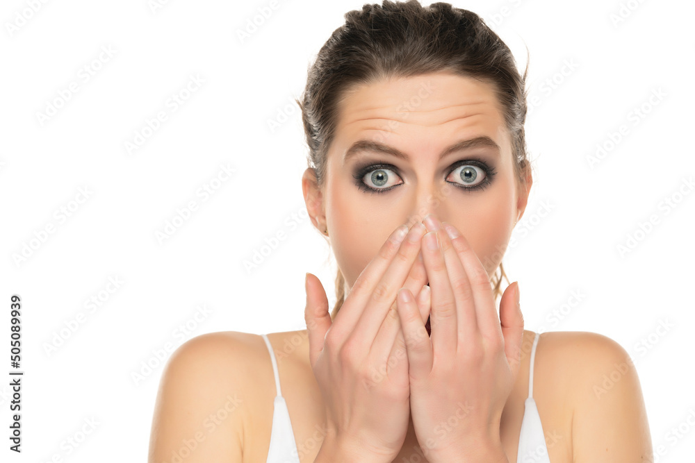 Image of shocked young lady with blue eyes and make up, posing isolated over white background Image of shocked young lady with blue eyes and make up, posing isolated over white background