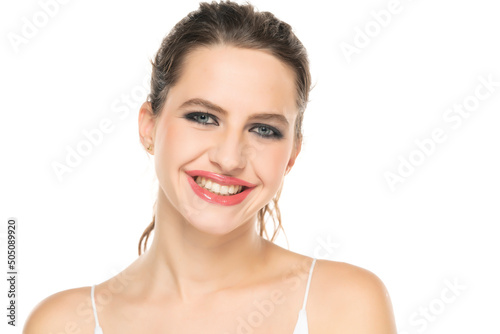 Beautiful happy woman with make up and tied hair on a white background