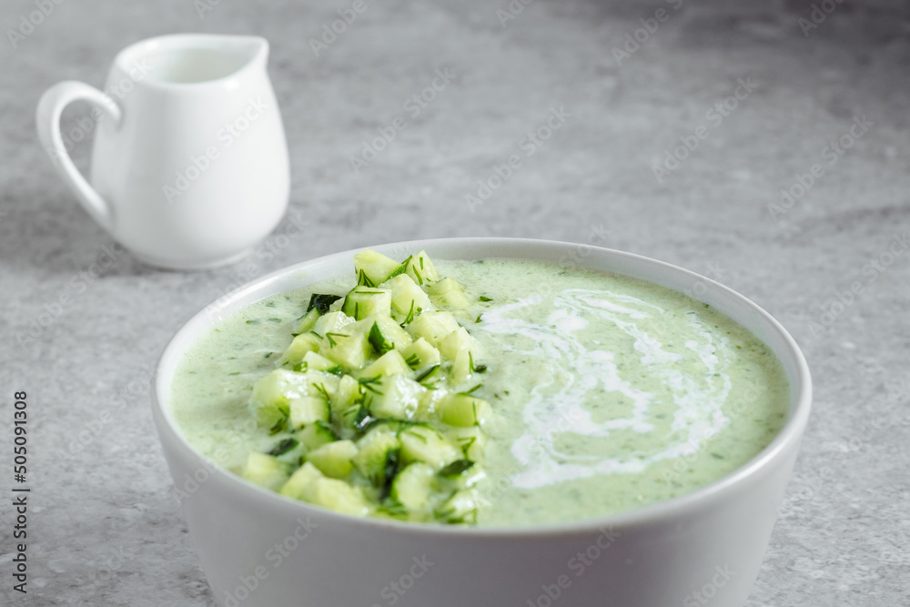 Cucumber Gazpacho. Green fresh cold summer soup on gray background