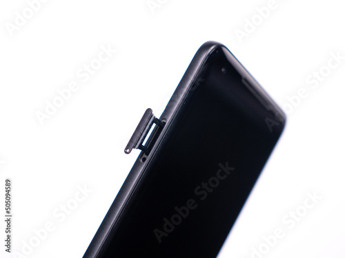 SIM tray for SIM card in smartphone close-up view on a white background
