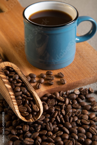 Blue cup of coffee with coffee beans 