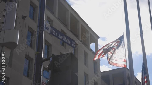 American flag waves at half-mast at Black Lives Matter Plaza in Washington D.C. photo