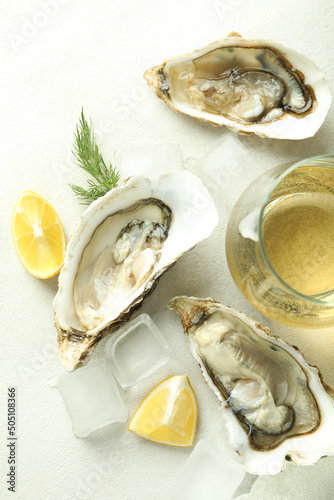 Concept of delicious seafood, oysters on white textured background