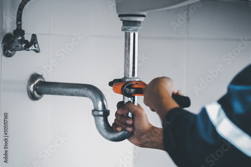 plumber at work in a bathroom, plumbing repair service, assemble