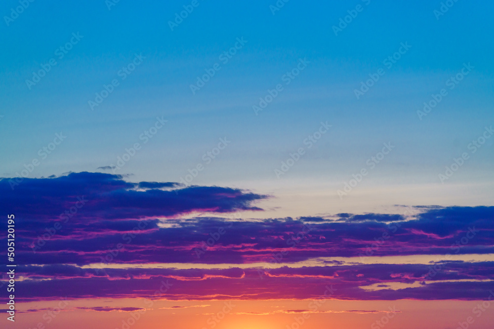 Mystical lighting. Clouds illuminated by the setting sun. Colorful sunset in the evening sky. Amazing sky panorama. Meditative calmness and greatness. Great dramatic view