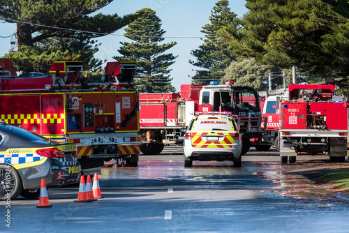 Scene with emergency service vehicles, ambulance, police, fire brigade photo