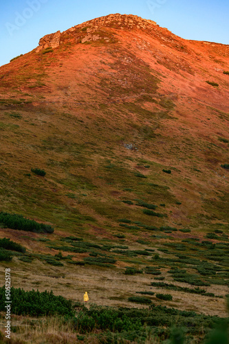 Woman is Mount Turkul, bright clothes in the mountains. photo