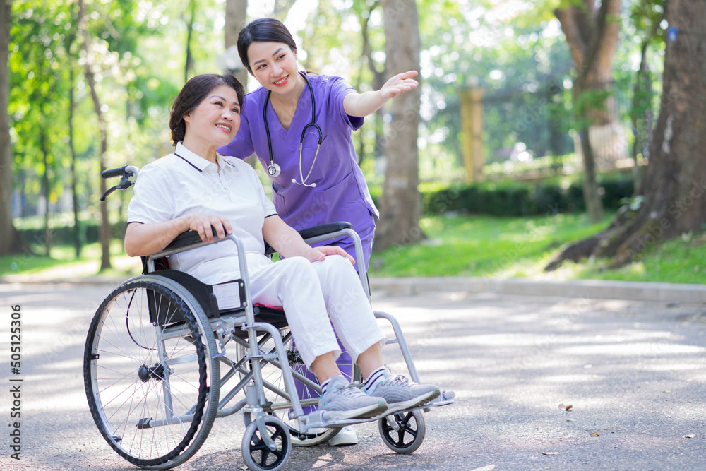 Asian female nurse taking care of a middle-aged female patient in the park Asian female nurse taking care of a middle-aged female patient in the park