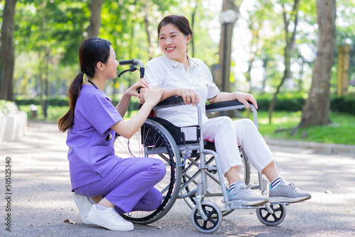 Asian female nurse taking care of a middle-aged female patient in the park