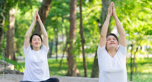 Image of Asian mother and daughter exercise at park