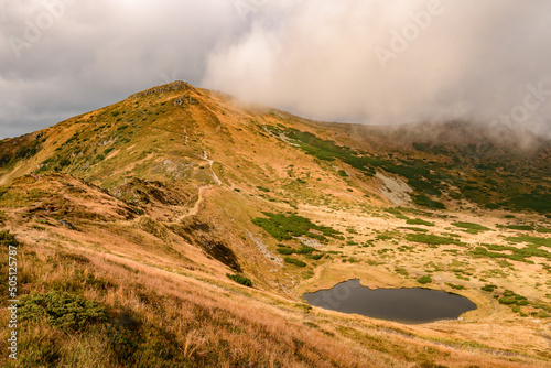 Lake Nesamovite and the surrounding landscape, the black water of the lake in autumn, autumn in the Carpathians. photo