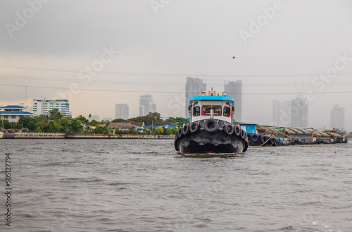 A Tugboat at the Chao Phraya River in Bangkok Thailand Asia photo