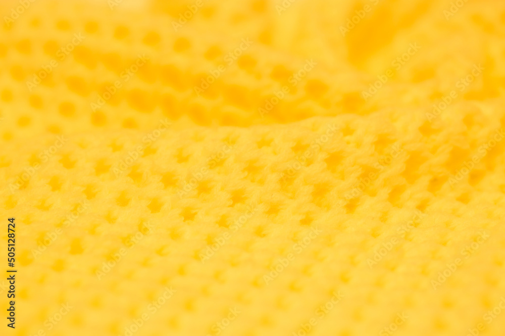 Knitted surface of woolen things as a background. Close-up of soft yellow knitted texture texture. Warm winter clothes. Background textile surface with copy space for text. Knitted surface of woolen things as a background. Close-up of soft yellow knitted texture texture. Warm winter clothes. Background textile surface with copy space for text.