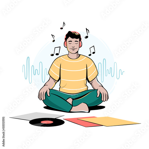 Boy, guy, young man sitting cross-legged, meditating and listening to music in headphones