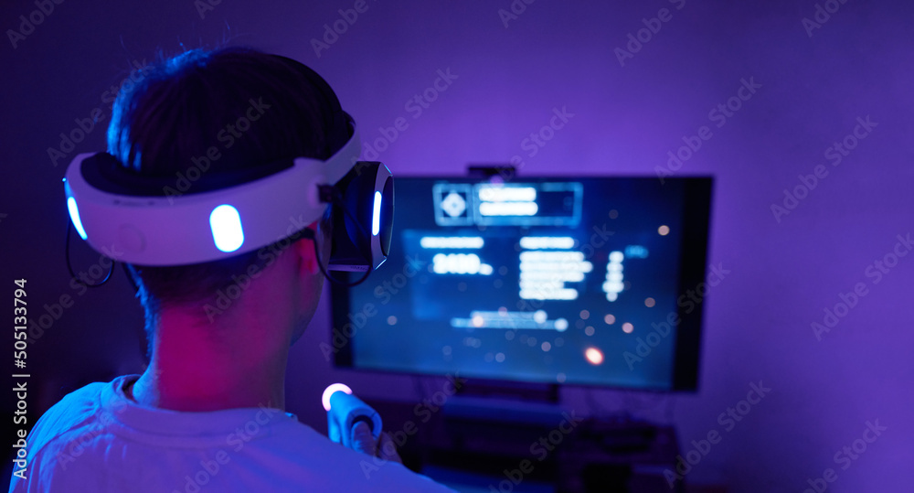 Man with virtual reality headset and joystic is playing game Man with virtual reality headset and joystic is playing game