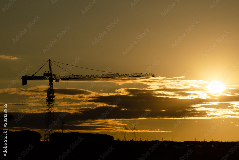 Crane and construction site sunset. Building development and construction concept