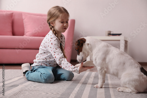 Wallpaper Mural Cute little girl playing with her dog at home. Childhood pet Torontodigital.ca