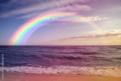 Beautiful view of colorful rainbow in sky over sea © New Africa