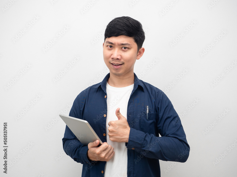 Asian man holding tablet and thumb up confident emotion Asian man holding tablet and thumb up confident emotion