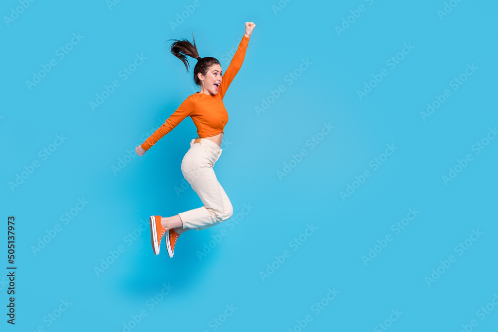 Full size profile side image of cheerful ecstatic girl look empty space win prize lottery isolated on blue color background