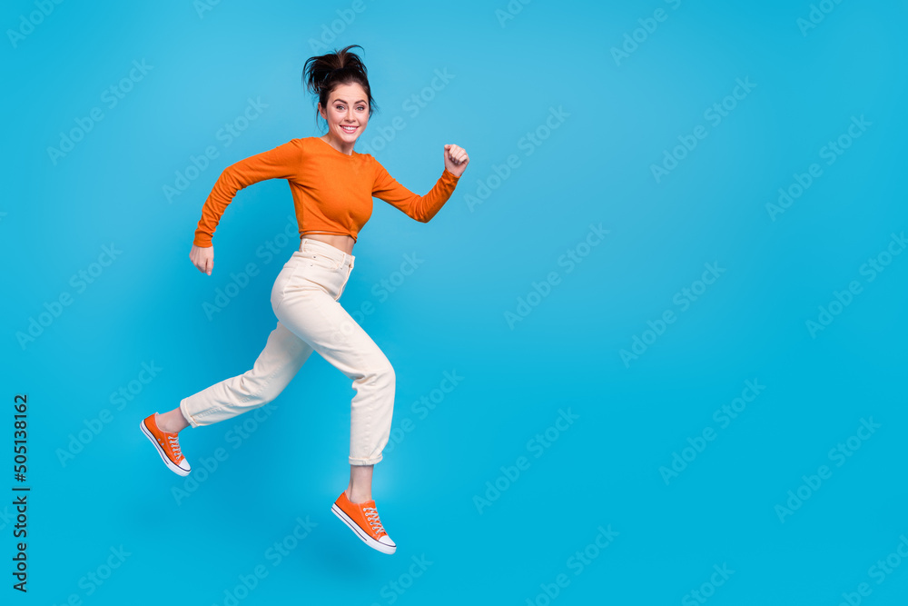 Full size profile side photo of cheerful charming energetic girl run traveling isolated on blue color background