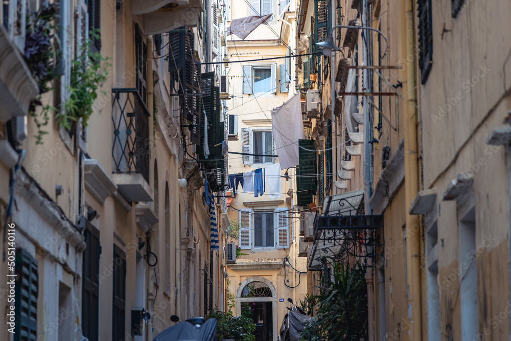 Narrow alley with residential building in historic part of Corfu city, capital of Corfu Island, Greece
