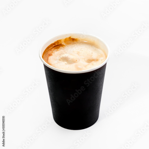 A paper cup with espresso coffee to take away. Close-up, on a white background